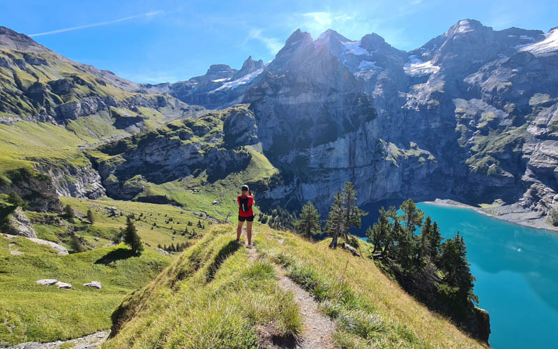 hiker on the panorama trail above the Oeschinensee with mountain views