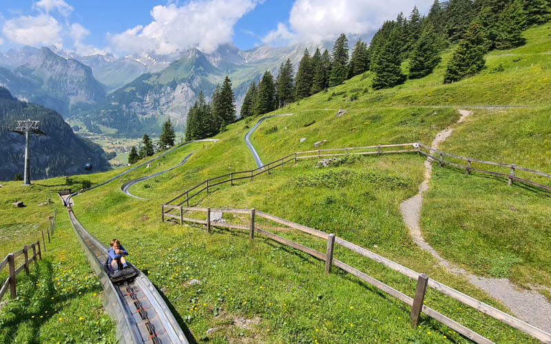 child riding up mountain coaster at Kandersteg Oeschinensee Switzerland