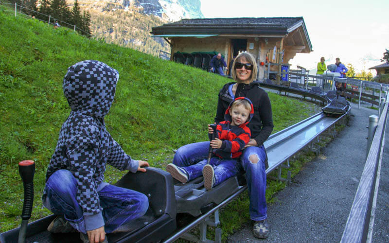 family riding mountain coaster at Grindelwald Pfingstegg Switzerland