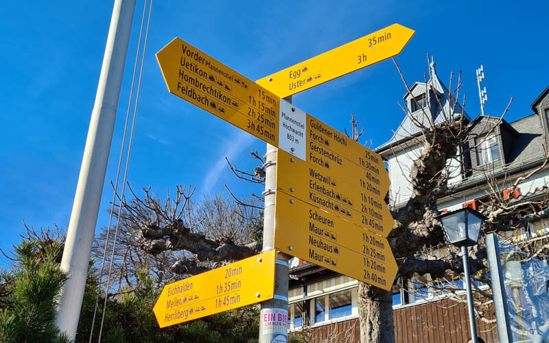 trail signs showing estimated times