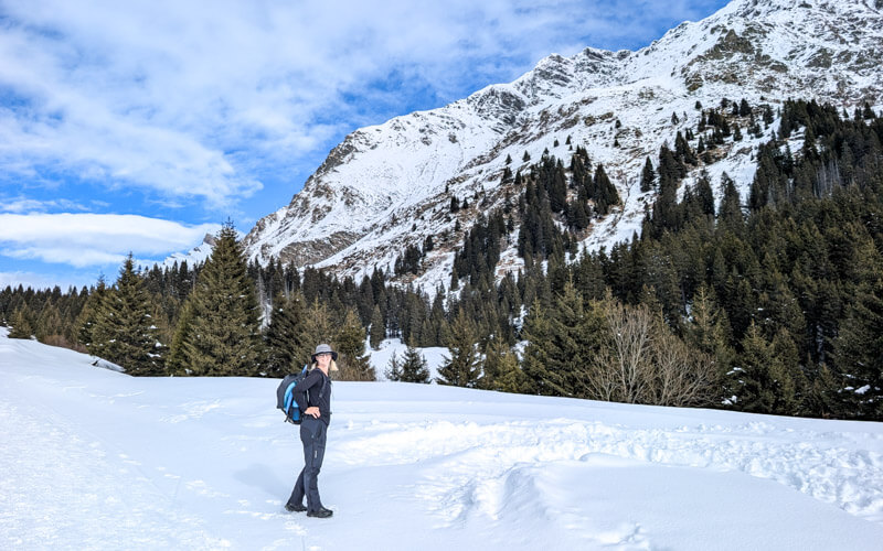 woman walking on groomed winter hiking trail at Pian Cales San Bernardino